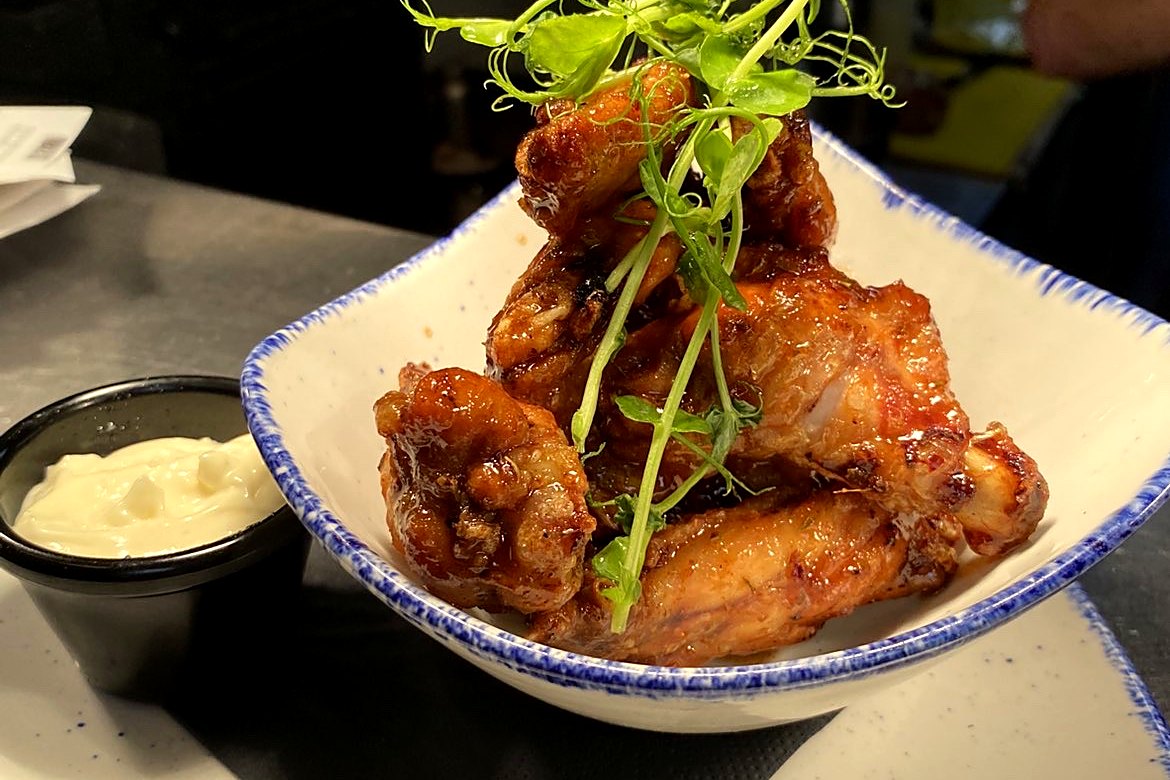 MKI Chicken Wings served in a bowl with blue cheese dip